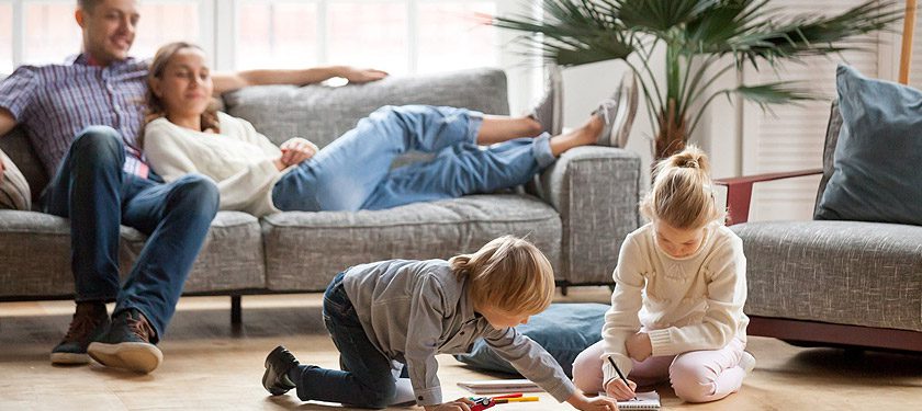 Couple with children sitting in Air Conditioned room